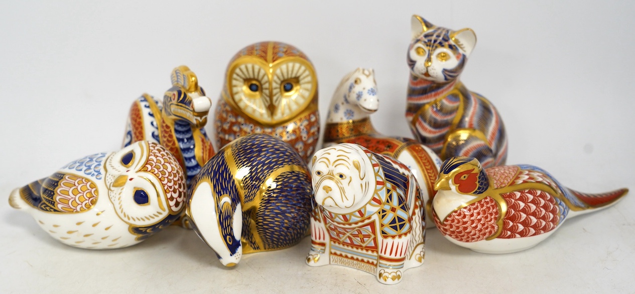 Eight Royal Crown Derby porcelain paperweights in the form of animals including a cat, badger and owl, largest 13.5cm high. Condition - good